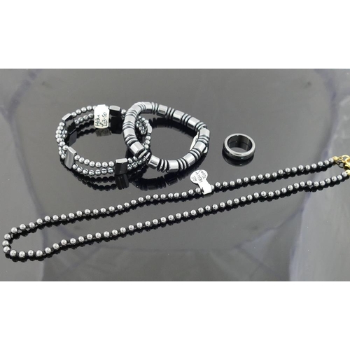 240 - A quantity of hematite jewellery comprised of two bracelets, an individually knotted beaded necklace... 