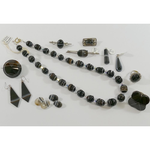 241 - A selection of striped onyx jewellery comprised of a graduated bead necklace with paste dividers, 12... 