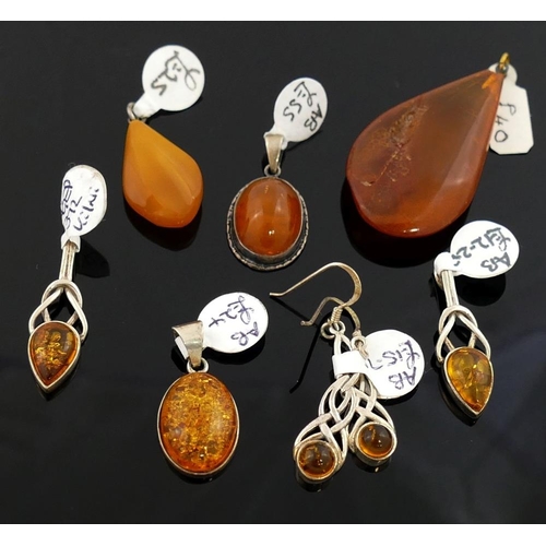 242 - A selection of amber jewellery comprised of a butterscotch amber pendant, 2.6cm long, a larger clari... 