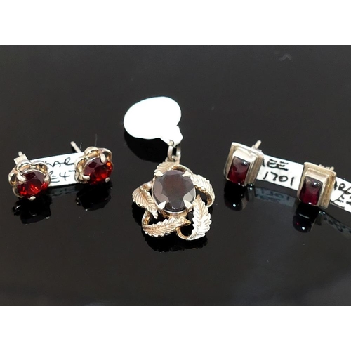 255 - A selection of garnet jewellery comprised of a brooch, two pairs of drop earrings, three single ston... 