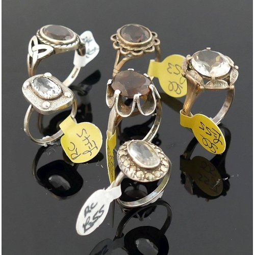 256 - Twelve rock crystal and smokey quartz set rings, most stamped 'silver' or '925', including a marcasi... 