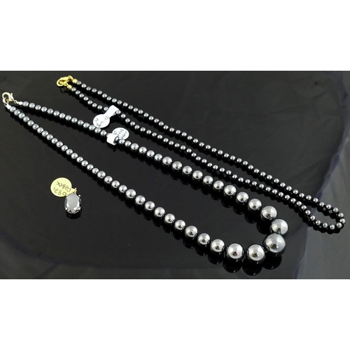 259 - A quantity of hematite jewellery comprised of two bracelets, an individually knotted beaded necklace... 