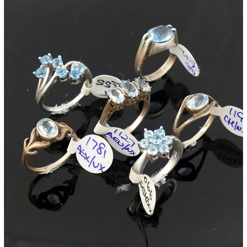 261 - A collection of 12 Swiss blue topaz set rings, including some set with marcasite, most stamped 'silv... 