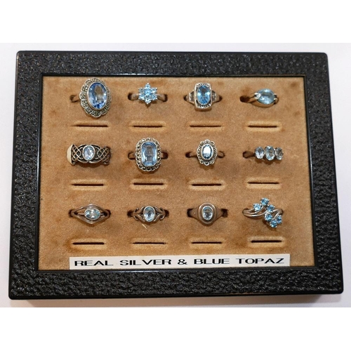 261 - A collection of 12 Swiss blue topaz set rings, including some set with marcasite, most stamped 'silv... 