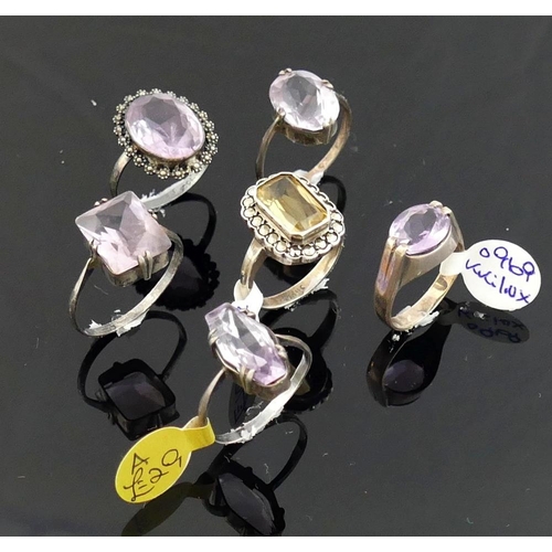 268 - A collection of 12 amethyst and citrine set rings, including some set with marcasite, most stamped '... 