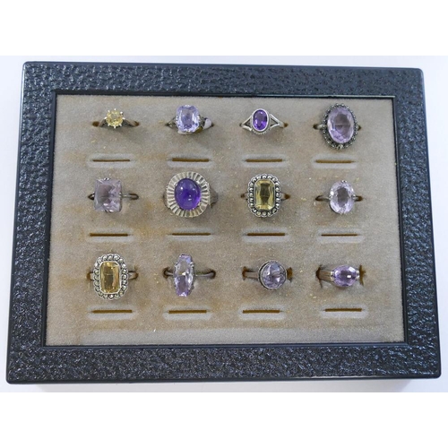 268 - A collection of 12 amethyst and citrine set rings, including some set with marcasite, most stamped '... 