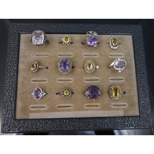 288 - A collection of 12 amethyst and citrine set rings, including some set with marcasite, most stamped '... 