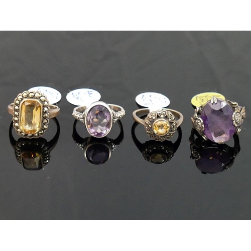 288 - A collection of 12 amethyst and citrine set rings, including some set with marcasite, most stamped '... 