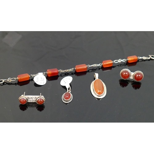 290 - A selection of carnelian jewellery comprised of a circular openwork brooch, another brooch, a bracel... 