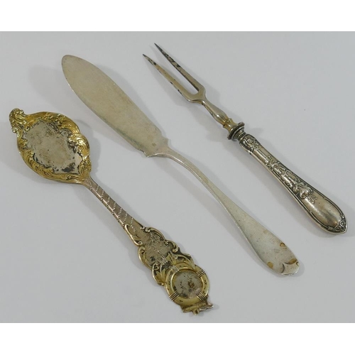 327 - An ornate gilt spoon stamped 'sterling' by J Ritter, a small silver butter knife, a silver napkin ri... 