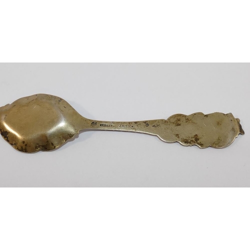 327 - An ornate gilt spoon stamped 'sterling' by J Ritter, a small silver butter knife, a silver napkin ri... 