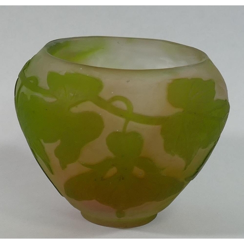 335A - A small cameo glass bowl in the style of Galle decorated in relief with trailing flowers to a cream ... 