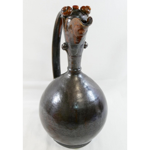 359 - A Turkish Canakkale pottery brown glazed ewer, 32cm high, and another Turkish pottery yellow and bro... 