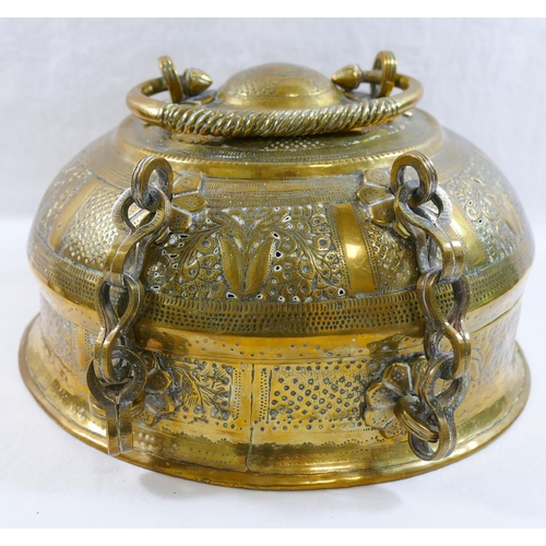 126 - A 19th century Indian circular brass betel nut pandan box, with ornately embossed decoration and car... 