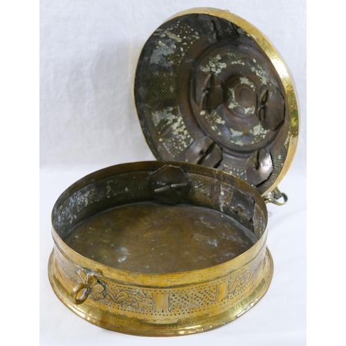 126 - A 19th century Indian circular brass betel nut pandan box, with ornately embossed decoration and car... 