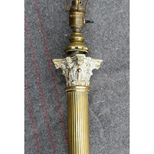 134 - An early 20th century brass telescopic Corinthian column standard lamp, raised on square base with l... 