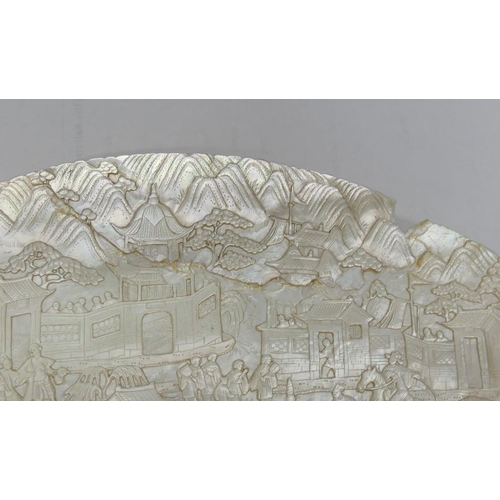 371 - A large Chinese carved mother of pearl shell intricately decorated with a battle scene amongst build... 