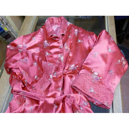 376 - A vintage red satin ladies dressing gown with chinoiserie floral machine embroidered decoration, and... 