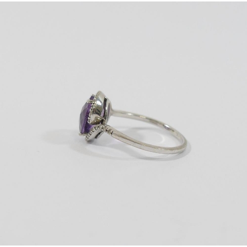 10 - A 9 carat white gold amethyst single stone ring within melee diamond surround and shoulders, Birming... 