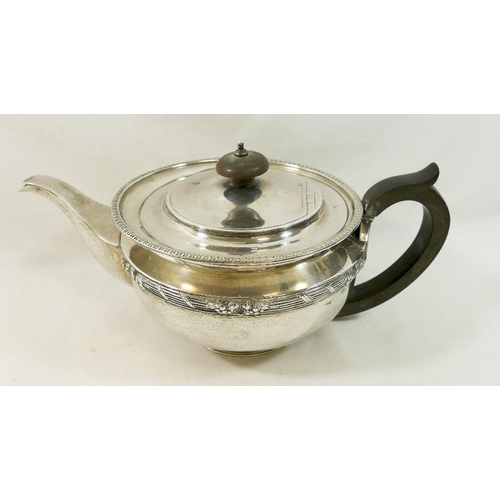 103 - A silver George V pedestal teapot, with ebonised handle and knop, the body with ornate reeded band, ... 