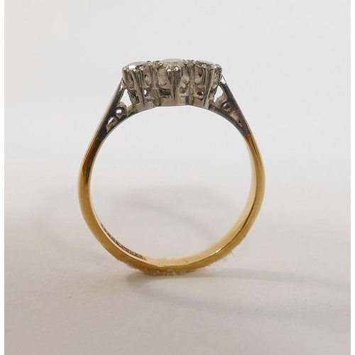 13 - A diamond three stone ring, combined weight approximately 0.18 carats, shank stamped '18CT & PLAT', ... 