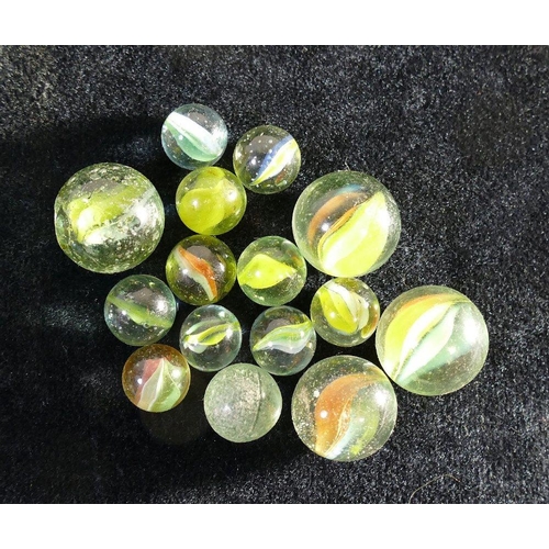 141 - A large assortment of glass marbles of various sizes, ages and styles including some with pontil mar... 