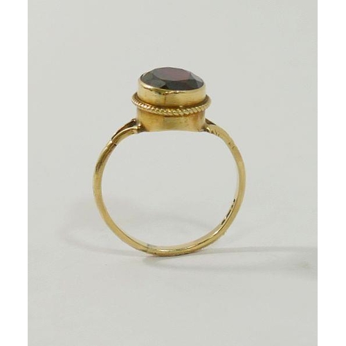 21 - A 9 carat gold single stone garnet ring, and a pair of 9 carat gold stud earrings of similar design,... 