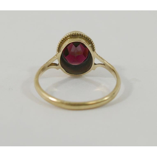 21 - A 9 carat gold single stone garnet ring, and a pair of 9 carat gold stud earrings of similar design,... 