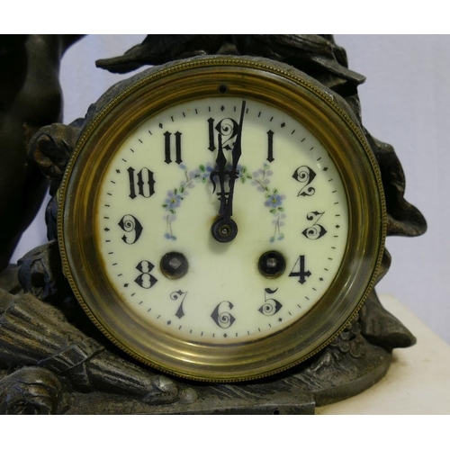 210A - A 19th century French marble and spelter mantle clock, the spelter clock mount cast in the form of C... 