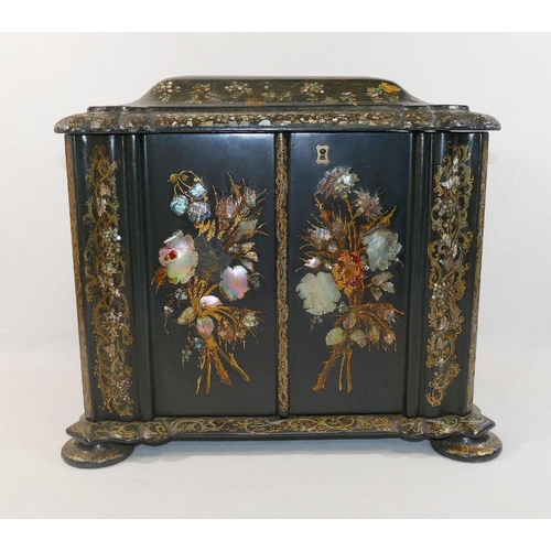 213 - A Victorian papier maché table top cabinet, inlaid with mother of pearl and decorated in gilt, the h... 