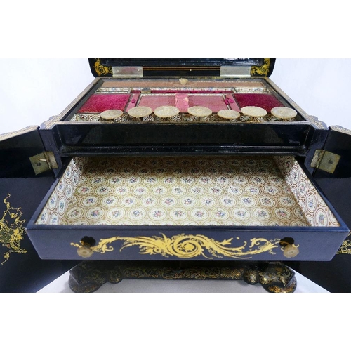 213 - A Victorian papier maché table top cabinet, inlaid with mother of pearl and decorated in gilt, the h... 