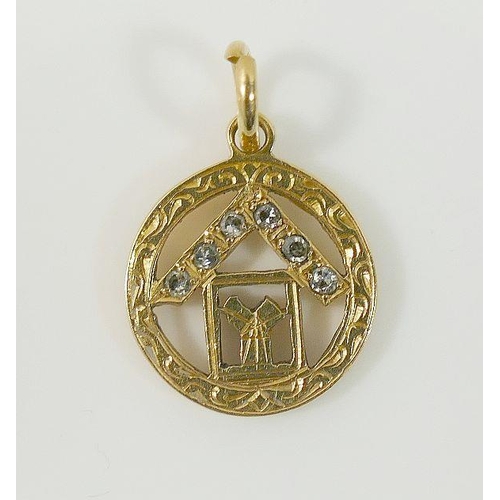 21A - A yellow metal circular pendant stamped '18K' with openwork Masonic design set with six eight-cut di... 