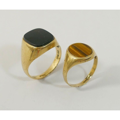 22 - Four 9 carat gold gem set rings, comprised of a sapphire half hoop ring, a tiger's eye set signet ri... 