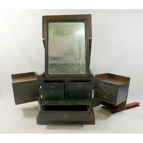 228A - A Chinese brass bound hardwood travelling vanity case, the hinged top fitted with mirror plate, the ... 