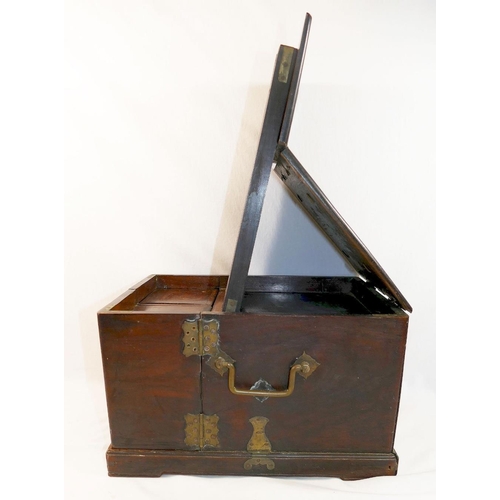 228A - A Chinese brass bound hardwood travelling vanity case, the hinged top fitted with mirror plate, the ... 