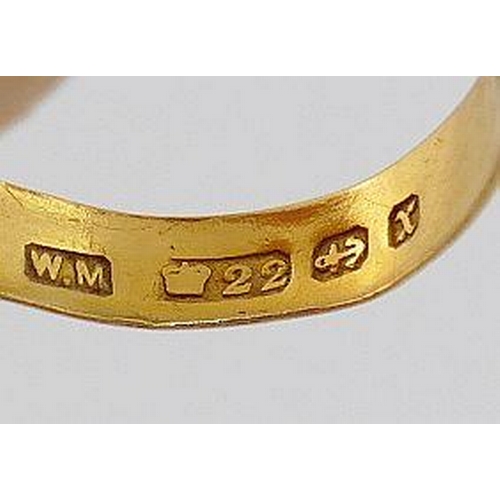 25 - A 22 carat gold wedding band, Birmingham 1897, mounted with rose gold ring head set with a single ga... 