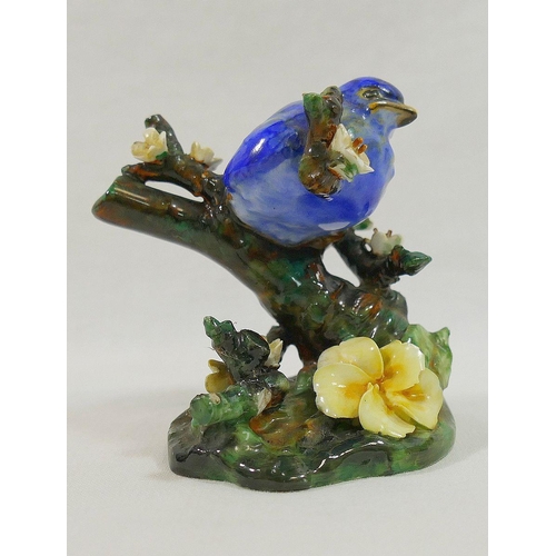 253 - A Royal Doulton bone china figure of a fledgling chick perched on a blossom covered branch, 7cm high... 