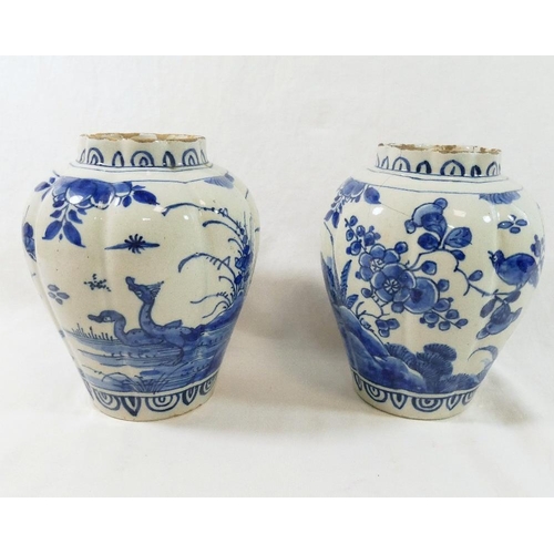 256 - A pair of 18th century Dutch delft lobed baluster vases, decorated with ducks and birds amongst blos... 