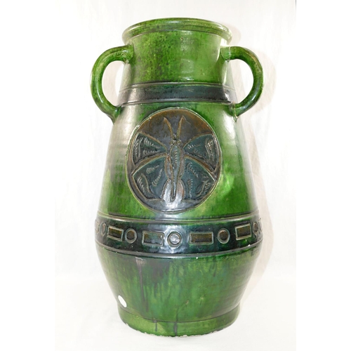 265A - A large Studio Pottery green glazed three handled vase, decorated with incised circular panels of bu... 