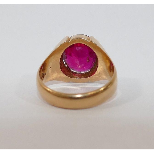 3 - A yellow metal single stone ring. the large oval mixed cut synthetic ruby in four claw setting, with... 