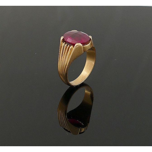 3 - A yellow metal single stone ring. the large oval mixed cut synthetic ruby in four claw setting, with... 