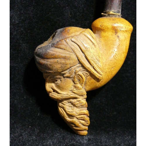 311A - A 19th century Meerschaum pipe, the bowl carved with the head of a bearded man, 9cm high, the pipe 2... 