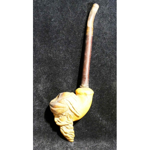 311A - A 19th century Meerschaum pipe, the bowl carved with the head of a bearded man, 9cm high, the pipe 2... 