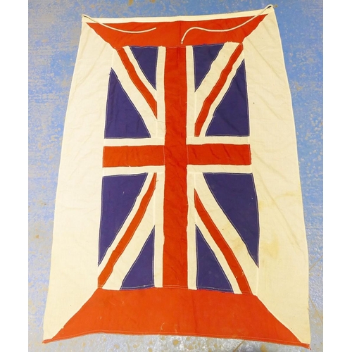 312A - A vintage British blue ensign flag 44cm x 83cm attached to a wooden pole and a vintage Union Jack fl... 