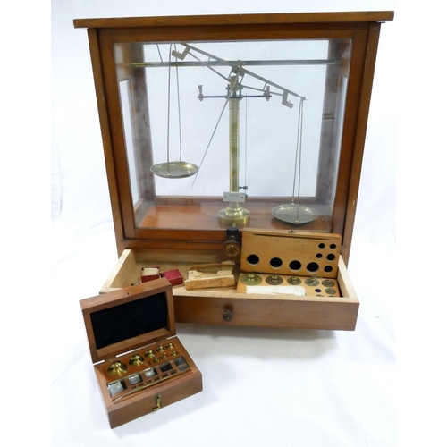 312 - A set of early 20th century brass apothecary/precision scales, housed in glazed wooden case, with tw... 