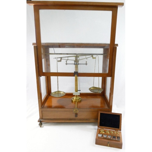 312 - A set of early 20th century brass apothecary/precision scales, housed in glazed wooden case, with tw... 