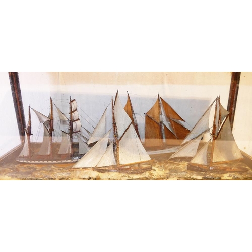 319 - A glass cased 19th century model of four sailing vessels in stormy seas, with handwritten note - '4 ... 