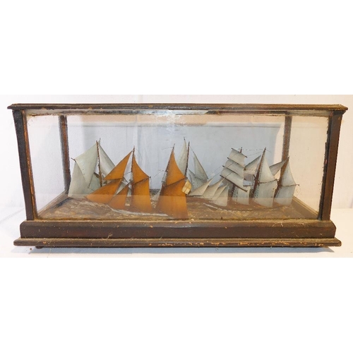 319 - A glass cased 19th century model of four sailing vessels in stormy seas, with handwritten note - '4 ... 