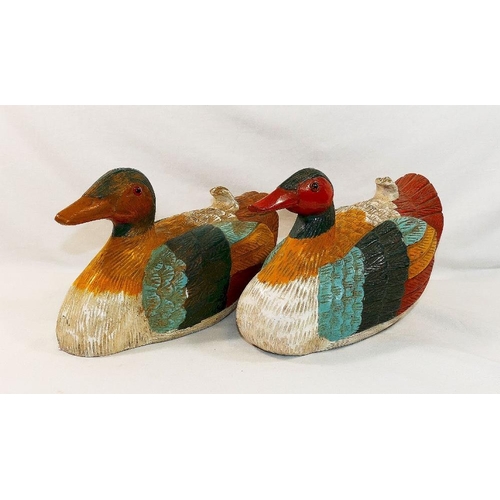 320 - A pair of ornamental painted  and carved wooden decoy style ducks, with glass eyes, 24cm long