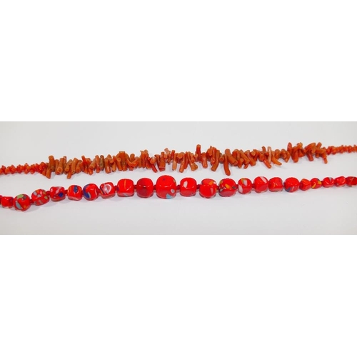 38 - A string of butterscotch amber beads, 69.5cm, the largest bead 1.4cm x 1.9cm, 36.4g gross, a coral b... 